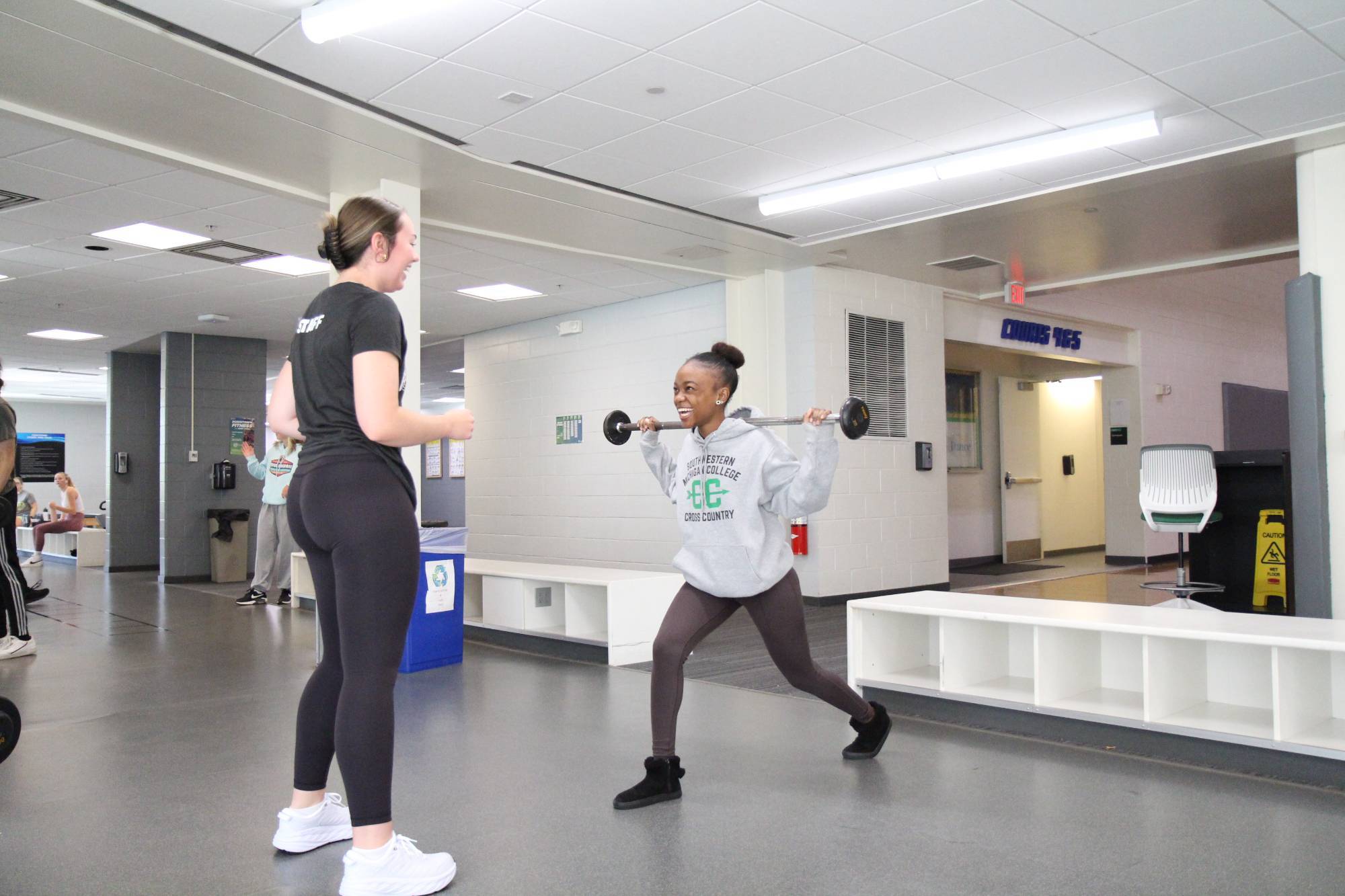 Personal trainer coaching client on lunges. 
